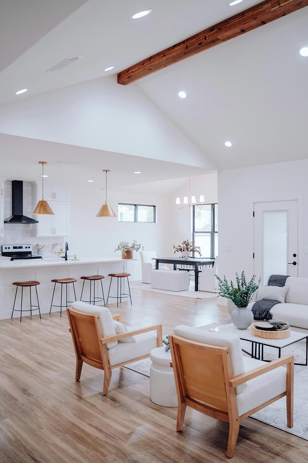 A bright open-concept living space with modern furniture and warm lighting.